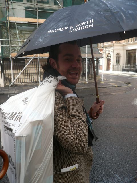 Antonio carrying two paintings he had just bought from Hauser & Wirth, wrapped in a garbage bag.