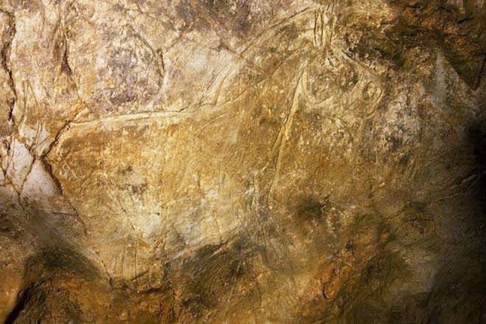 Hornos de la Peña, Cantabria. The cave walls are etched with images of horses and other animals, carved with striking clarity and movement.