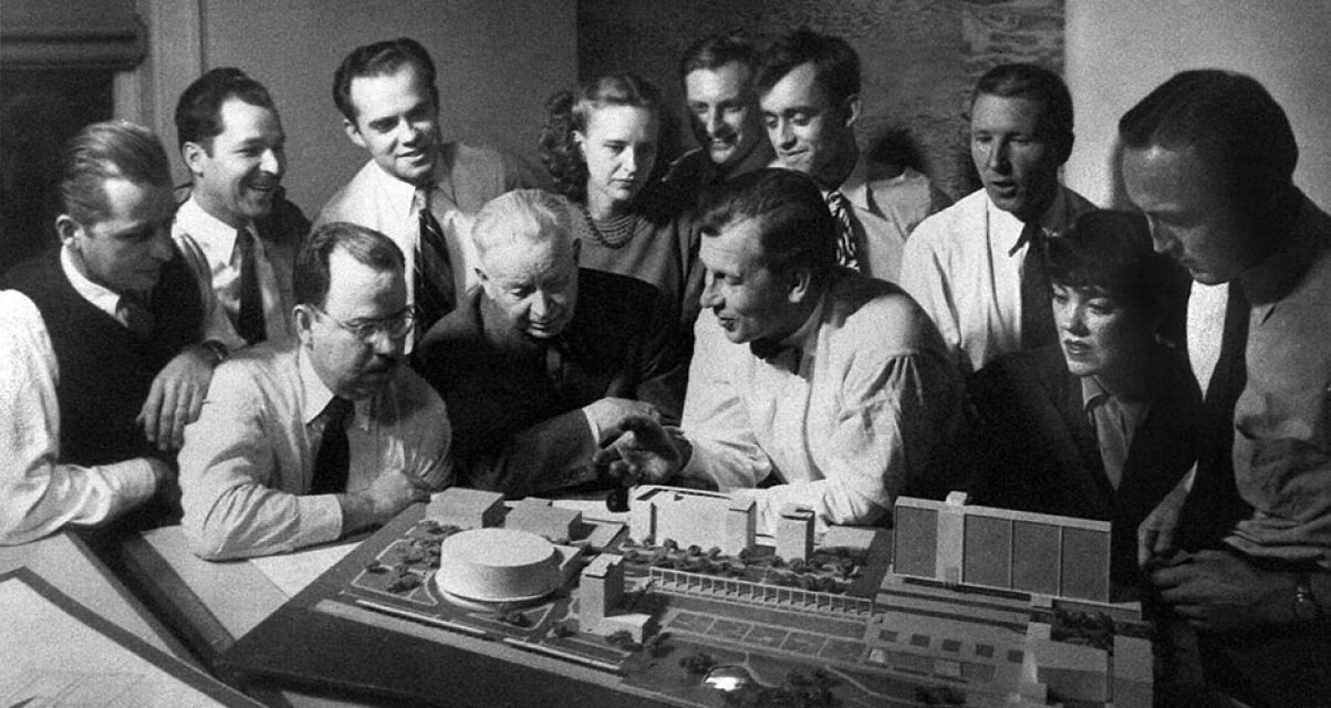 Eero Saarinen and his team gathered around an architectural model, c. 1948.