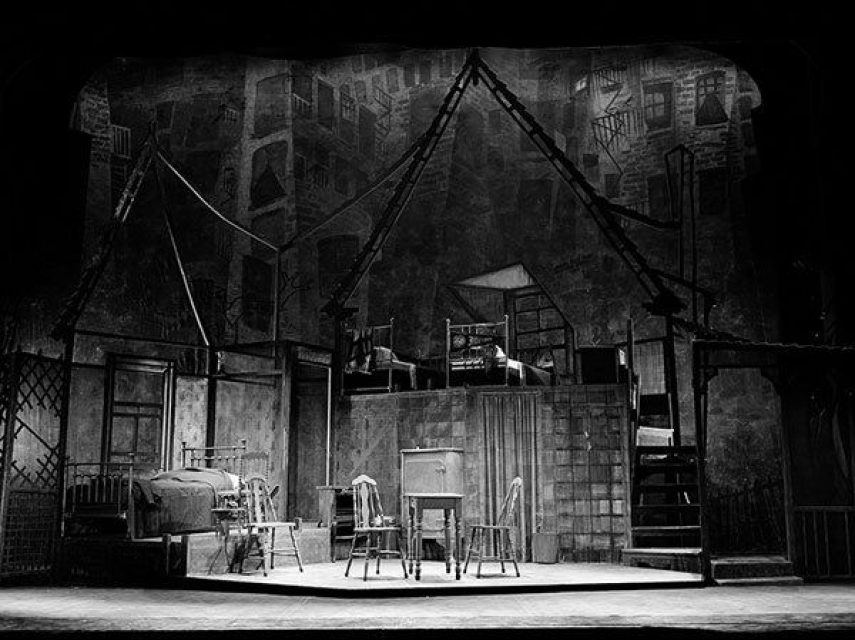 In Death of a Salesman, the painted cityscape contrasts sharply with Jo Mielziner’s fragmented, realistic set pieces