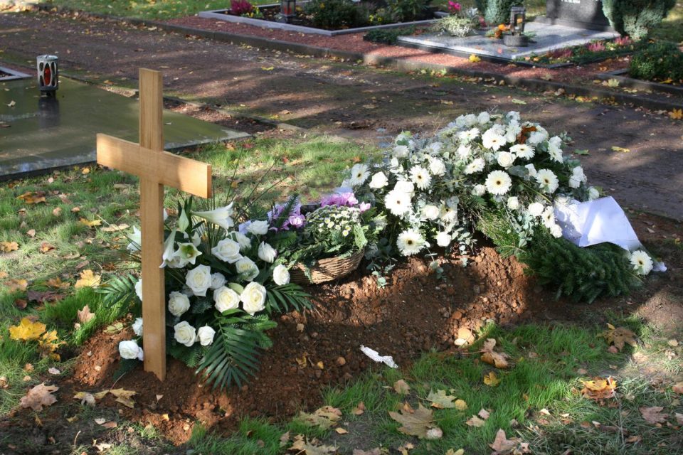 A freshly filled grave, with the earth left raised to allow for settling and subsidence. The gravestone is added months later, once the ground has stabilized.