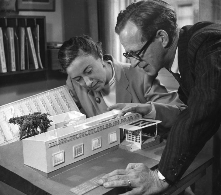 Architects Jane Drew and Maxwell Fry examining one of their models.