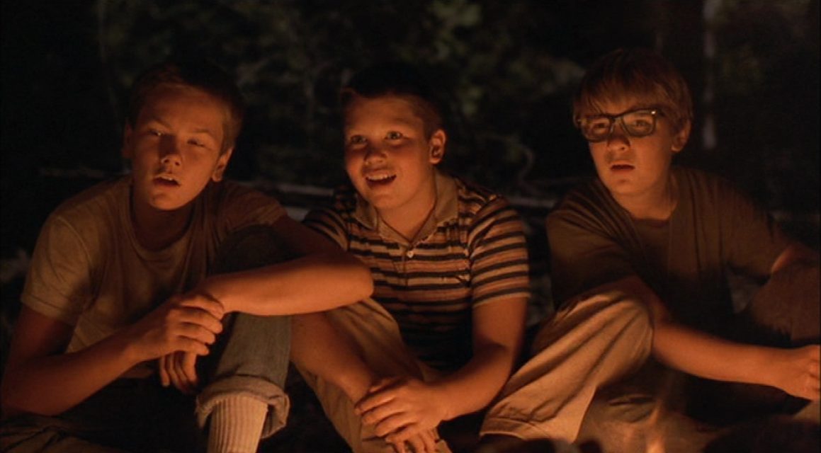 The campfire scenes in Stand by Me (1986) create a feeling of shelter from the unknown that lurks around.